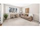 Inviting living room with a beige couch, desk, large window and carpeted floors at 6497 Cape Hatteras Ne Way # 3, St Petersburg, FL 33702