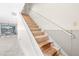 Carpeted staircase showcases the unfinished potential for a new homeowner at 6497 Cape Hatteras Ne Way # 3, St Petersburg, FL 33702