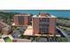 Wide angle aerial showcasing waterfront condo buildings, community pool, parking, and manicured landscaping at 7432 Sunshine Skyway S Ln # 406, St Petersburg, FL 33711