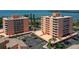 Aerial view of waterfront condos featuring multiple balconies, parking facilities, and landscaped grounds at 7432 Sunshine Skyway S Ln # 406, St Petersburg, FL 33711