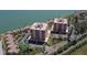 Aerial view of waterfront condos with lush landscaping, offering serene views and convenient parking at 7432 Sunshine Skyway S Ln # 406, St Petersburg, FL 33711