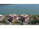 Stunning aerial view showcasing two waterfront condo buildings with multiple balconies and manicured landscaping at 7432 Sunshine Skyway S Ln # 406, St Petersburg, FL 33711