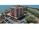 Waterfront condo exterior view with multiple balconies, parking, and well-maintained landscaping at 7432 Sunshine Skyway S Ln # 406, St Petersburg, FL 33711