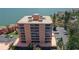 Exterior showcasing waterfront condo building featuring balconies, parking, and beautifully landscaped surroundings at 7432 Sunshine Skyway S Ln # 406, St Petersburg, FL 33711
