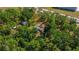 Aerial view showcases the home surrounded by lush trees and foliage, offering a sense of seclusion at 7537 Old Pasco Rd, Wesley Chapel, FL 33544