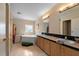 Bathroom featuring double sinks, a large tub and tile flooring at 7537 Old Pasco Rd, Wesley Chapel, FL 33544