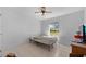 A simple bedroom with tile flooring, neutral walls, and a single window at 7537 Old Pasco Rd, Wesley Chapel, FL 33544