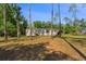 Charming single-story home featuring a welcoming facade and a well-maintained lawn at 7537 Old Pasco Rd, Wesley Chapel, FL 33544