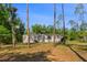 Single story home with an attached carport and mature trees in a sprawling yard at 7537 Old Pasco Rd, Wesley Chapel, FL 33544