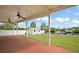 Spacious covered patio offers views of the backyard, shed, dock, and canal, ideal for outdoor entertaining at 8932 Rocky Creek Dr, Tampa, FL 33615