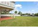 A large grassy backyard features a shed, dock, and water views, perfect for outdoor enjoyment and relaxation at 8932 Rocky Creek Dr, Tampa, FL 33615