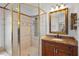 Bathroom featuring shower stall, granite countertop, and wood cabinets at 8932 Rocky Creek Dr, Tampa, FL 33615