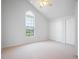Bright bedroom boasts carpet, a ceiling fan, and large windows with natural light at 8932 Rocky Creek Dr, Tampa, FL 33615