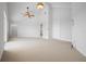 Large vaulted ceiling bedroom with carpet, walk-in closet, and ensuite bathroom access at 8932 Rocky Creek Dr, Tampa, FL 33615