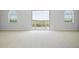 Spacious bedroom with carpet and double doors leading to outdoor patio at 8932 Rocky Creek Dr, Tampa, FL 33615
