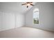 Bedroom with neutral carpet, closets and a fan at 8932 Rocky Creek Dr, Tampa, FL 33615