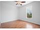 Bedroom featuring brown floors, white walls, and a large window at 8932 Rocky Creek Dr, Tampa, FL 33615