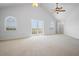 Spacious bedroom with vaulted ceiling, carpet, and double doors to the outside at 8932 Rocky Creek Dr, Tampa, FL 33615