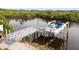 Aerial view of the waterfront dock and boat lift, offering a glimpse of the serene boating lifestyle at 8932 Rocky Creek Dr, Tampa, FL 33615