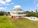 This beautiful elevated home offers spacious living with multiple balconies, a garage, and a large yard at 8932 Rocky Creek Dr, Tampa, FL 33615