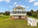Inviting two-story home with a charming balcony, a spacious screened lanai, and a convenient ground-level garage at 8932 Rocky Creek Dr, Tampa, FL 33615