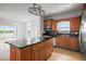 Gourmet kitchen featuring granite countertops, stainless steel appliances and custom cabinetry at 8932 Rocky Creek Dr, Tampa, FL 33615
