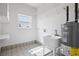 Well-lit laundry room with a sink and Rheem Performance Platinum water heater at 8932 Rocky Creek Dr, Tampa, FL 33615