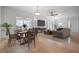 Open concept living room with a dining table, sofa, and large windows at 8932 Rocky Creek Dr, Tampa, FL 33615