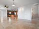 Bright, open living space with tile floors leading to the kitchen and stairway at 8932 Rocky Creek Dr, Tampa, FL 33615