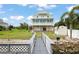 Two story home with a screened in porch, a walkway to the water, and a shed in the backyard at 8932 Rocky Creek Dr, Tampa, FL 33615