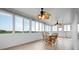 Bright sunroom features a dining area, ceiling fans, and plenty of natural light at 8932 Rocky Creek Dr, Tampa, FL 33615