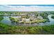 Aerial view showcasing waterfront homes nestled along canals and estuaries, with lush greenery surrounding the community at 8940 Rocky Creek Dr, Tampa, FL 33615