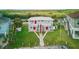 Aerial view showing two-story apartments featuring elevated porches, complemented by green lawns in a waterfront setting at 8940 Rocky Creek Dr, Tampa, FL 33615