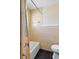 Bathroom featuring neutral tile, a shower/tub, and a toilet at 8940 Rocky Creek Dr, Tampa, FL 33615