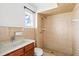 Tiled bathroom includes shower, toilet, sink, and window at 8940 Rocky Creek Dr, Tampa, FL 33615
