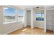 Well-lit bedroom with hardwood floors, closet and two windows at 8940 Rocky Creek Dr, Tampa, FL 33615