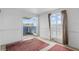 Empty bedroom with carpet flooring, white walls, and a walk-out balcony at 8940 Rocky Creek Dr, Tampa, FL 33615