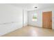 Empty bedroom with neutral tiling, a window and door at 8940 Rocky Creek Dr, Tampa, FL 33615