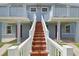 Two story duplex with walkways to the entrance featuring matching red doors at 8940 Rocky Creek Dr, Tampa, FL 33615