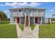 Two story duplex with walkway to the entrances, and matching red doors at 8940 Rocky Creek Dr, Tampa, FL 33615