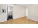 Hallway with wood floors leading to a bathroom with black floors at 8940 Rocky Creek Dr, Tampa, FL 33615