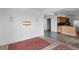 Open living room and kitchen area with light wood cabinets and new laminate floors at 8940 Rocky Creek Dr, Tampa, FL 33615