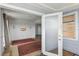 Open living room features a glass door, carpet, and is painted white at 8940 Rocky Creek Dr, Tampa, FL 33615