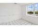 Living Room featuring white walls, tile floors and lots of light from the large window at 8940 Rocky Creek Dr, Tampa, FL 33615