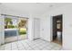 Living Room featuring white walls, tile floors, door to outside patio and multiple entryways at 8940 Rocky Creek Dr, Tampa, FL 33615