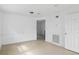 Spacious room with tile floors, white walls and baseboards with a door leading to another room at 8940 Rocky Creek Dr, Tampa, FL 33615