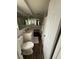 Bathroom with a corner vanity, framed mirror, and wood-look flooring at 9815 Wayside Ln, Port Richey, FL 34668