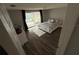 Bedroom with sliding glass door to outdoor area, neutral tones, and wood-look flooring at 9815 Wayside Ln, Port Richey, FL 34668