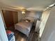 Neutral bedroom with a wood-framed bed, ceiling fan, and wood-look flooring at 9815 Wayside Ln, Port Richey, FL 34668