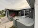 Inviting front porch featuring seating, unique architectural details, and ample natural light at 9815 Wayside Ln, Port Richey, FL 34668